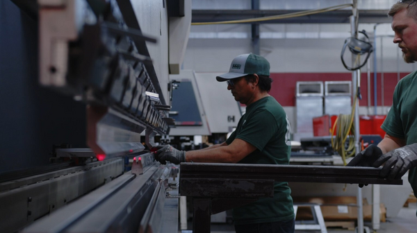 Operators at work on a press brake in a HACO production hall